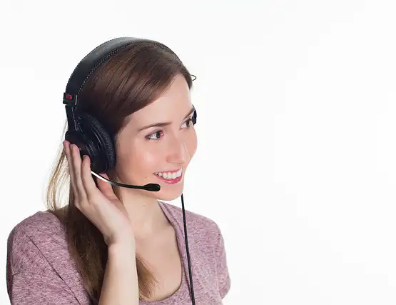 Smiling woman wearing headset with microphone in customer service or call center role