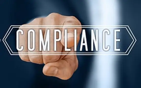 Business professional pointing at compliance text with finger in digital interface concept
